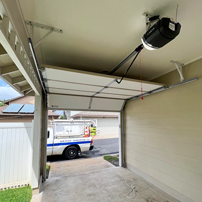 image of garage door installation with Raynor Hawaii truck in the background